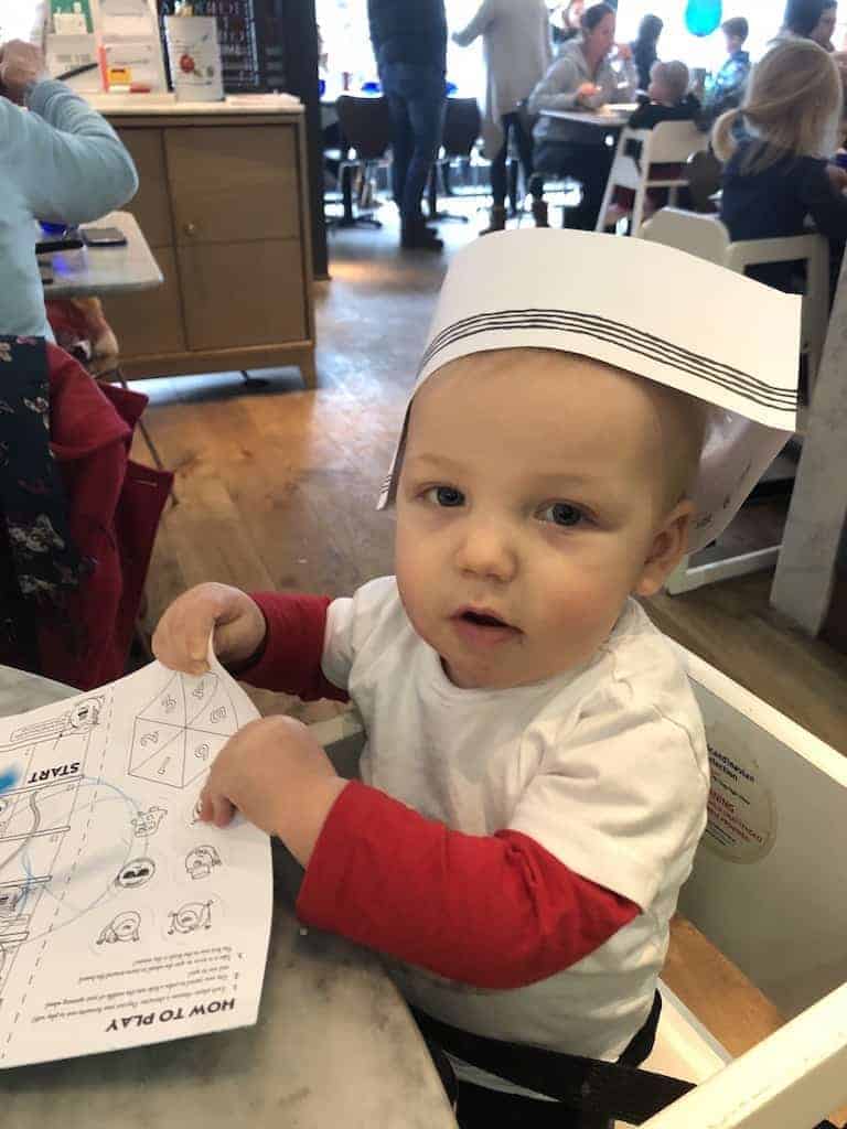 Boy eating allergy friendly pizza at Pizza Express restaurant