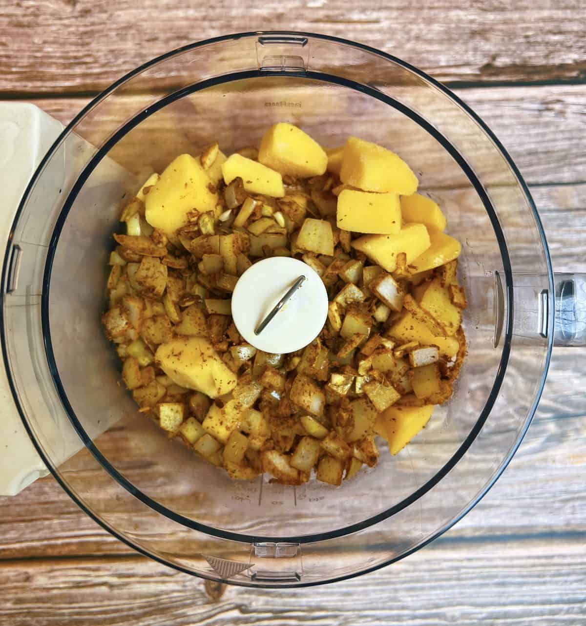 Mango, onion, garlic, ginger and spices in food processor