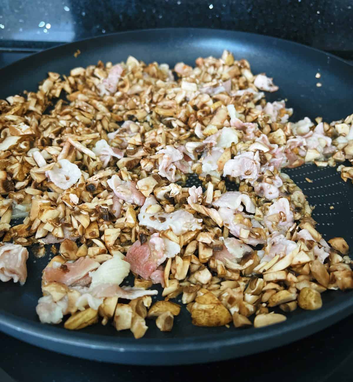 bacon and mushroom frying in a pan