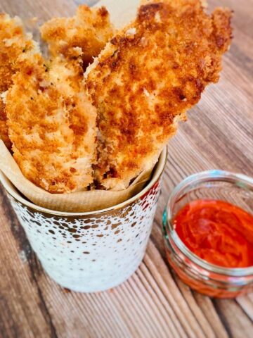 chicken goujons in a pot with ketchup