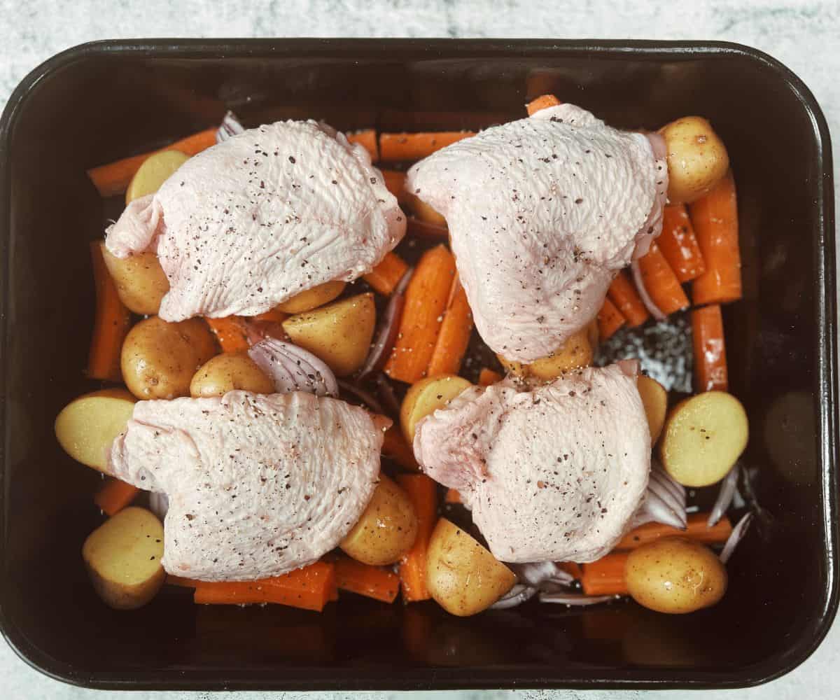 chicken potatoes and vegetables in a roasting tin