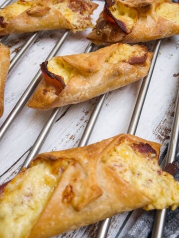 gluten free bacon and cheese pastry turnovers on a cooling rack