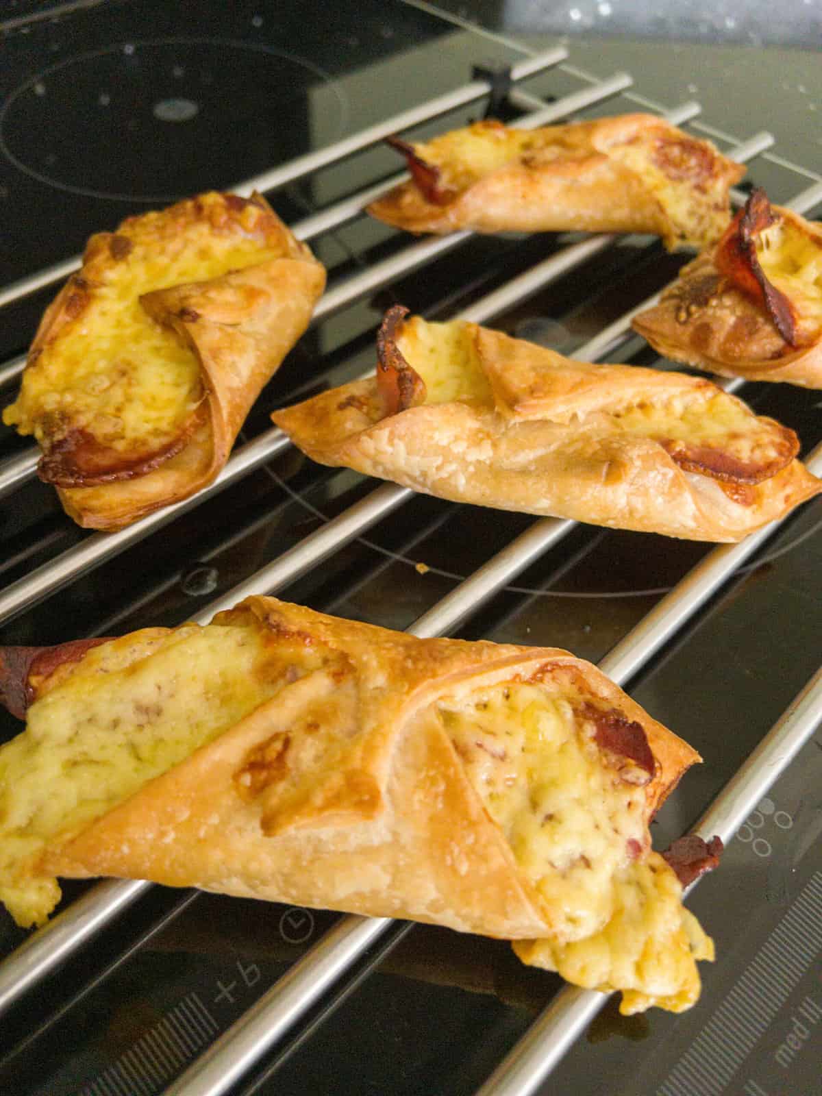 cheese and bacon turnovers cooling on a cooling rack.