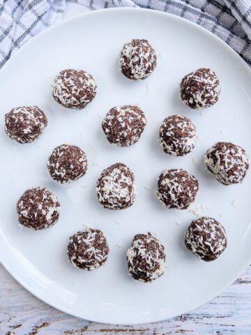 date energy balls on a white plate
