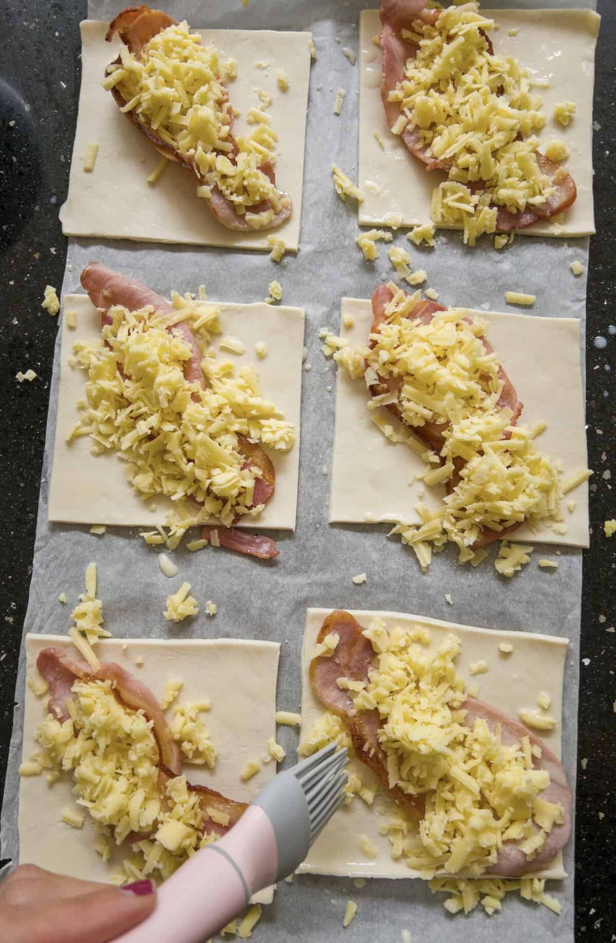 bacon cheese and pastry squares on greaseproof paper