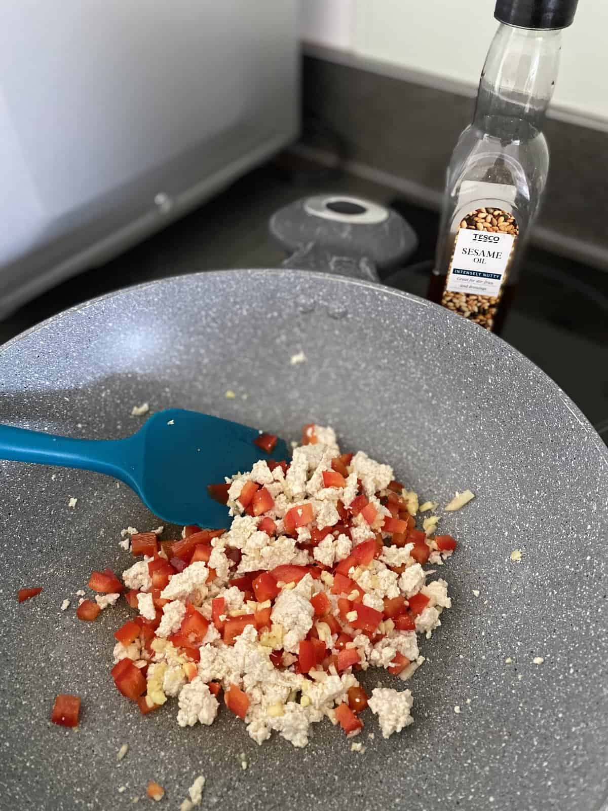 tofu and red pepper in a frying pn