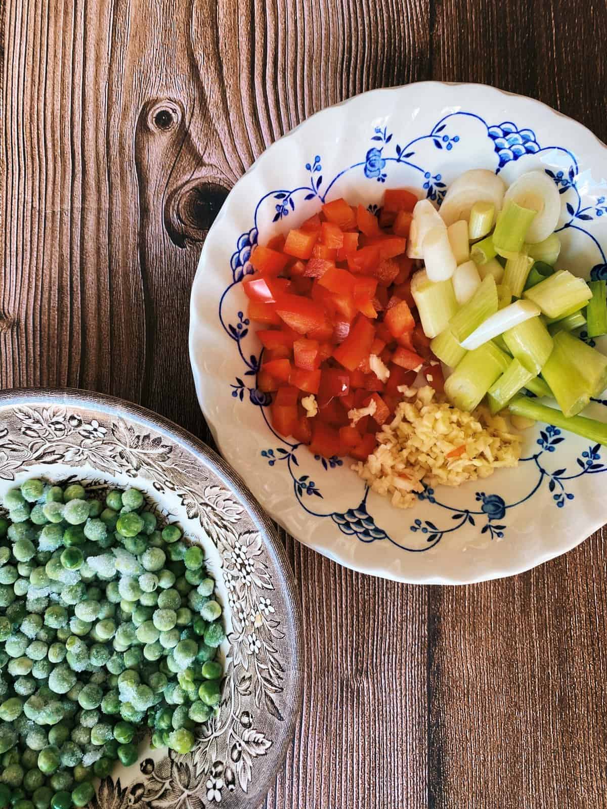 peas red pepper spring onion galric and ginger in a bowl