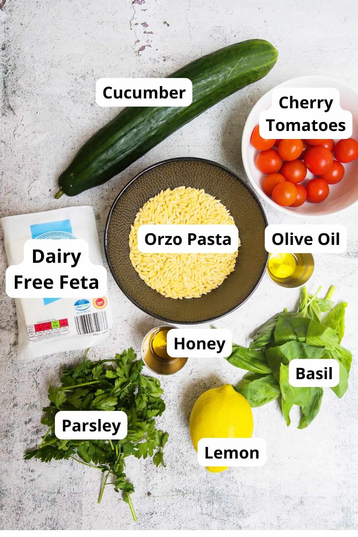 ingredients laid out for a lemon orzo pasta salad with cucumber and feta