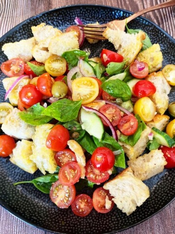panzanella bread salad with tomatoes basil and olives.