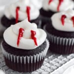 chocolate cupcakes with vanilla frosting and red icing to make them look like vampires.