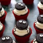cupcakes decorated with oreos, edible eyes and icing to look like spiders.