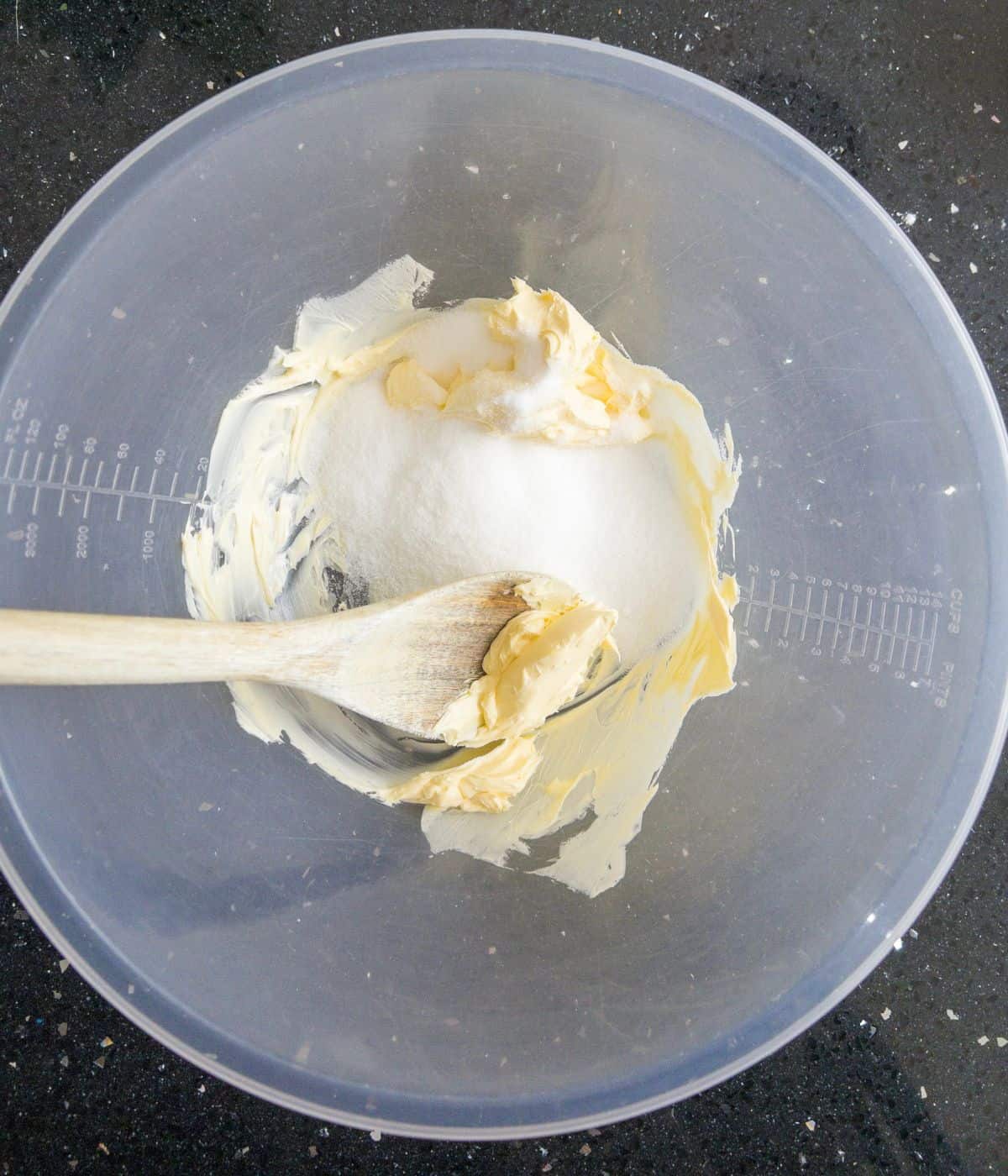 butter and sugar being beaten together in a mixing bowl.