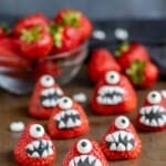 strawberries decorated with faces to look like monsters.