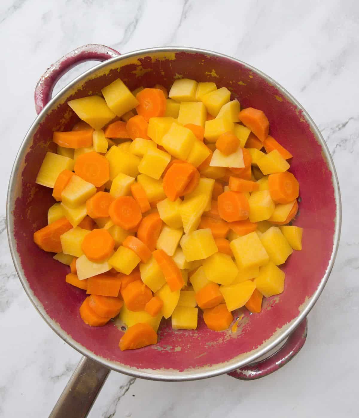 chopped carrot and swede in a colander.