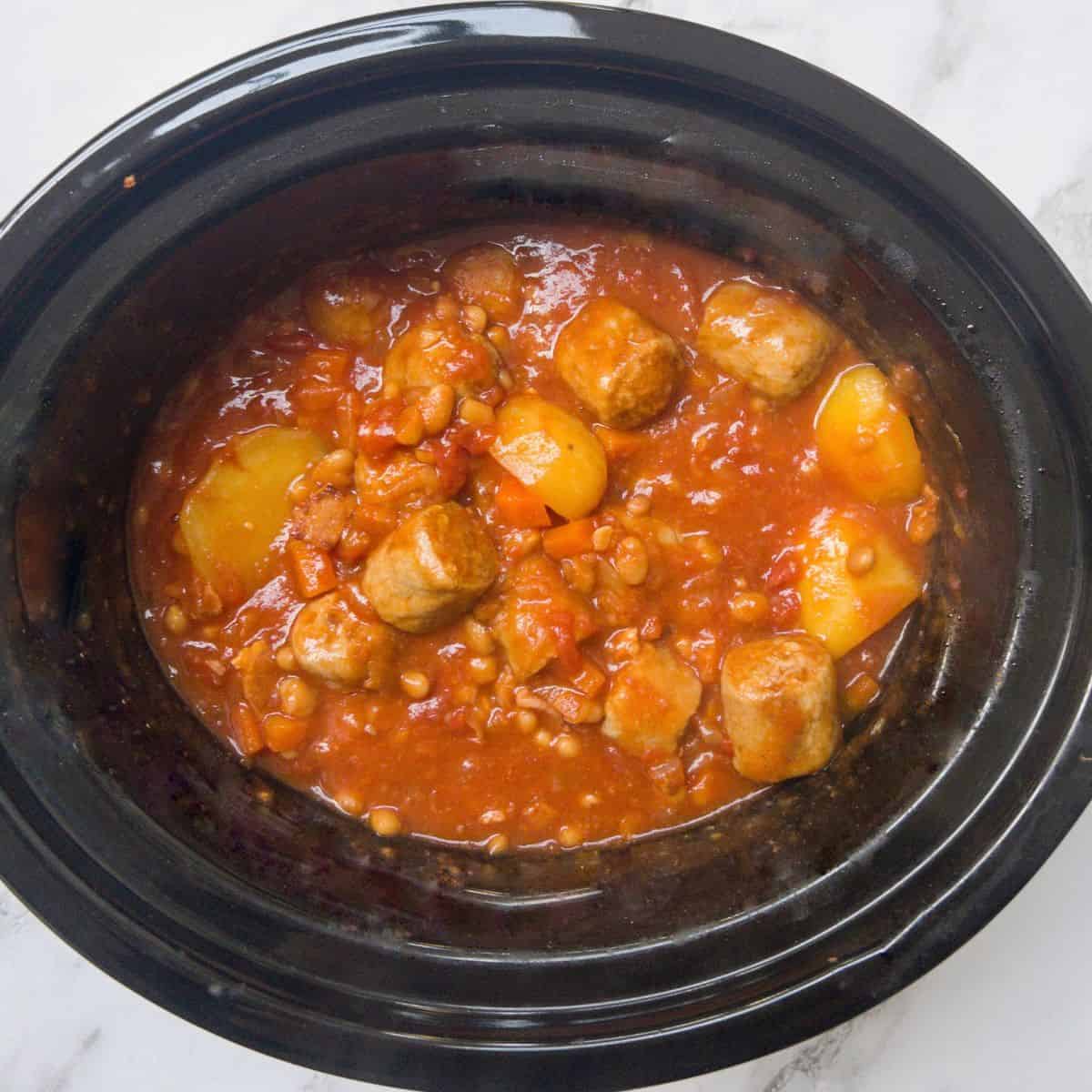 sausage and baked bean casserole cooking in the slow cooker.