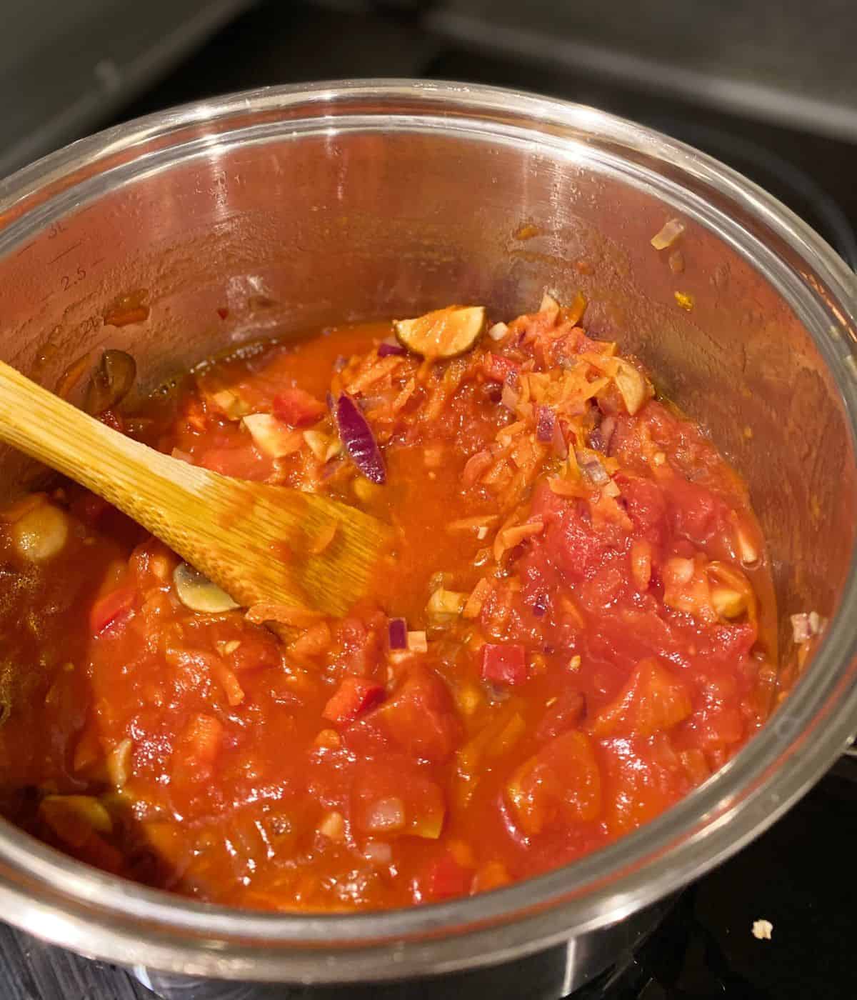 chunky tomato sauce cooking in a saucepan.