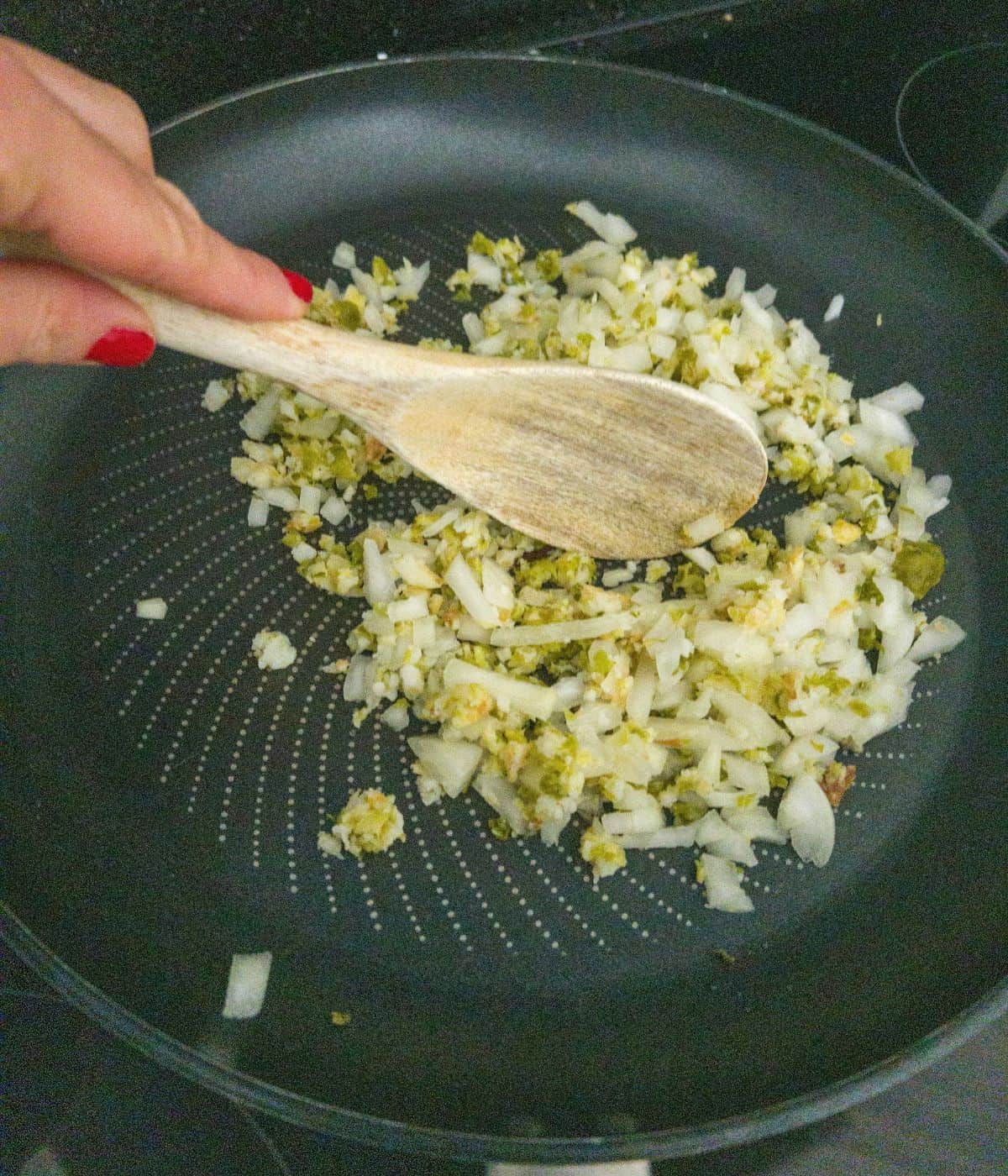 Onions frying in a frying pan.