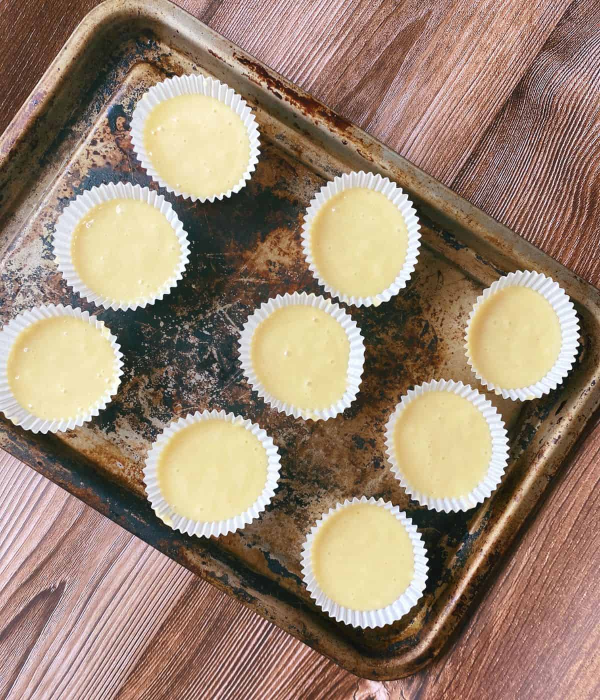 unbaked cupcakes in cases on a baking tray