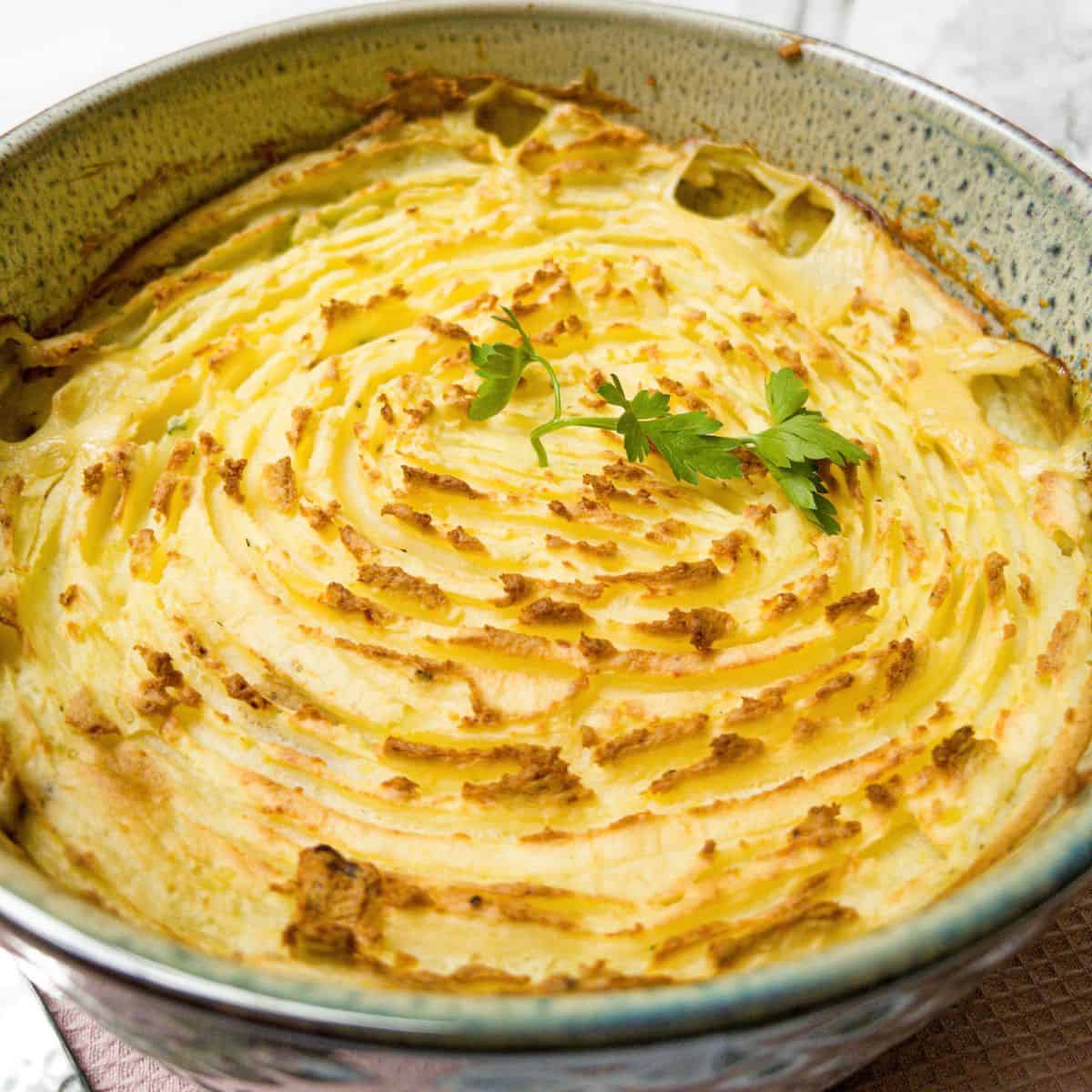 Close up shot of dairy free fish pie in a casserole dish.