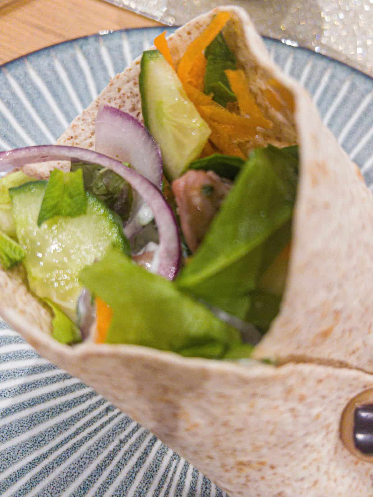 Wrap filled with lamb and salad.