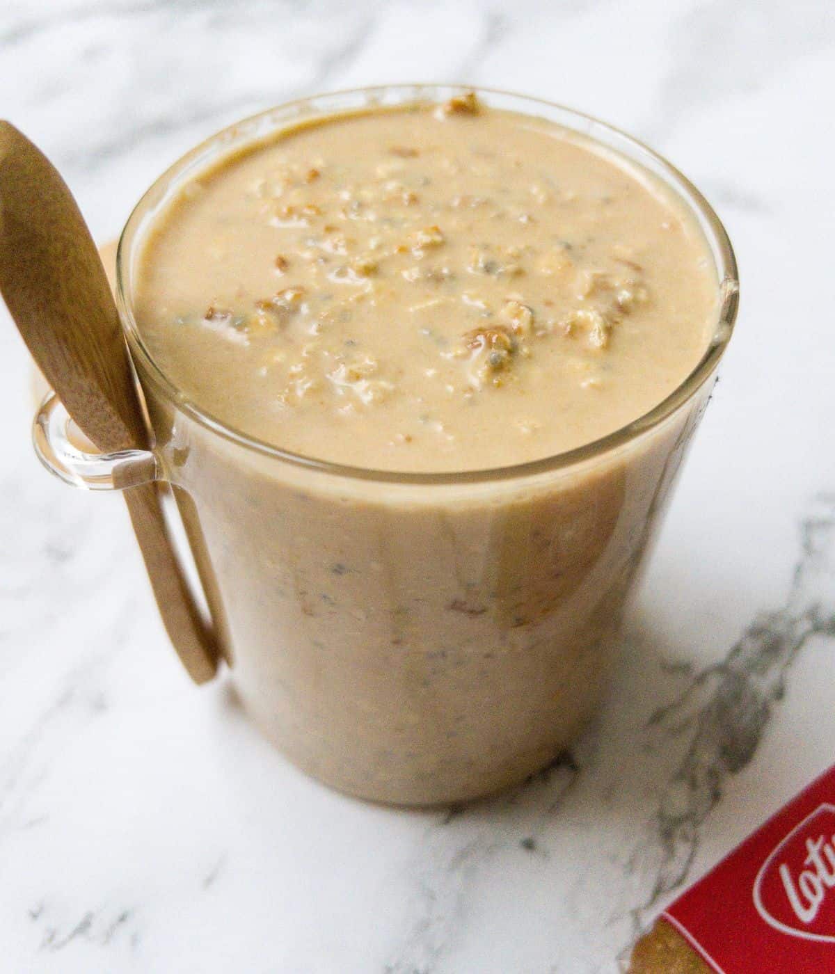 oats mixed with milk, biscoff spread and chia seeds in a glass jar.