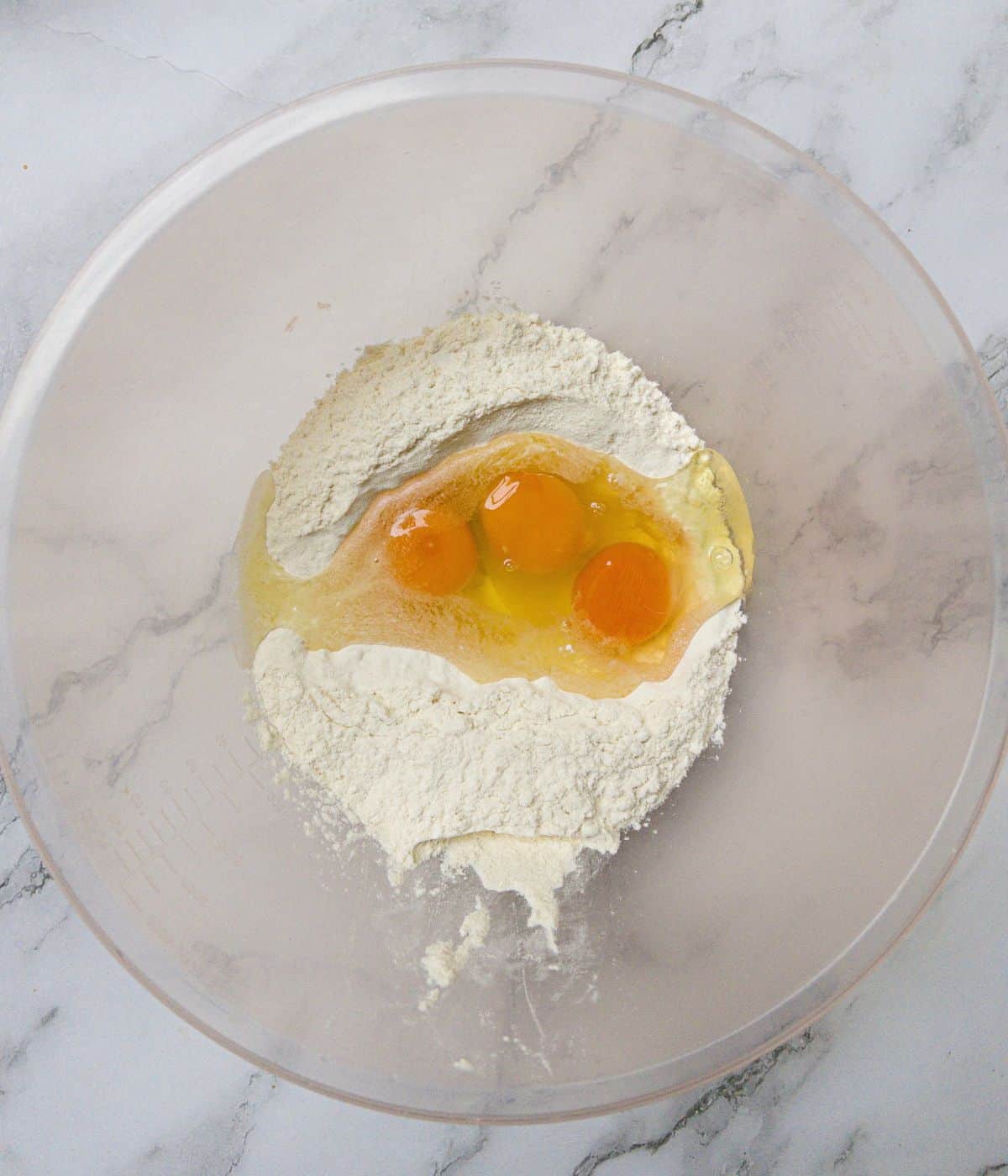 Eggs and flour in a mixing bowl.