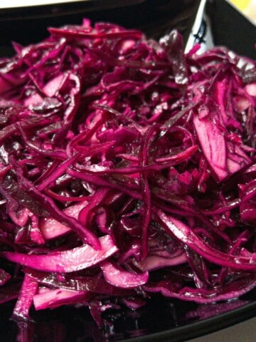 Shredded red kebab shop style cabbage in a black bowl.