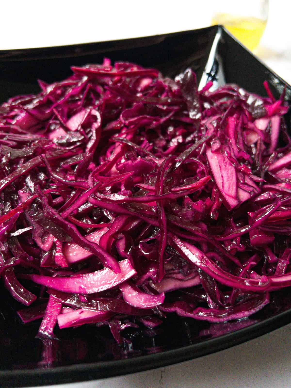 Shredded red kebab shop style cabbage in a black bowl.