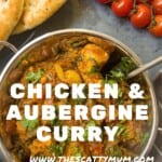 Chicken curry in a silver balti bowl with some vine tomatoes and naan bread in the background.