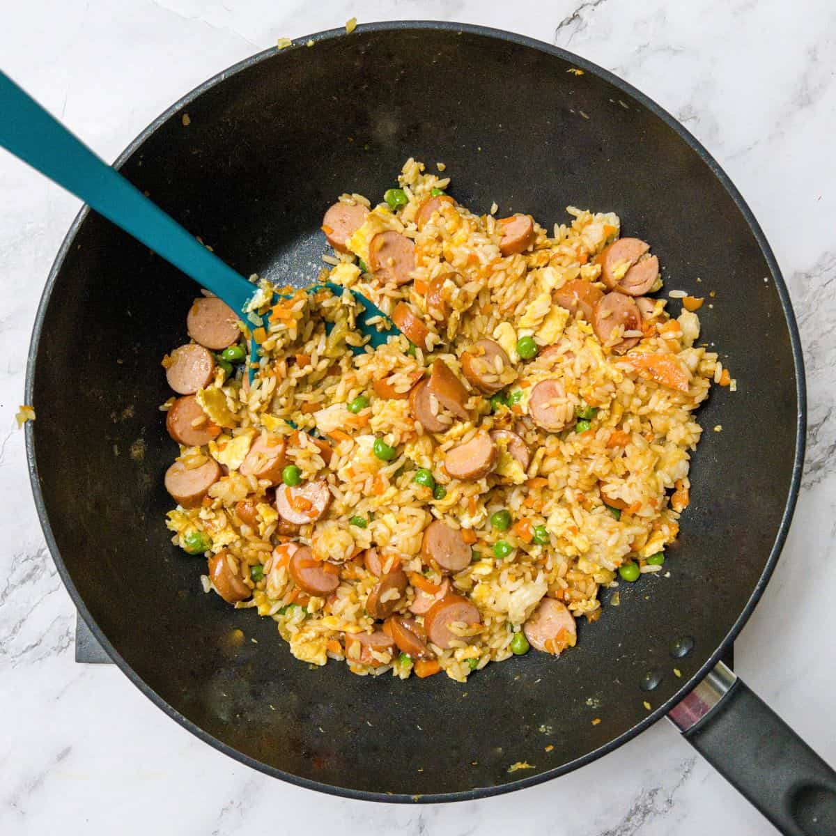 Hot dog fried rice in a wok.
