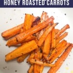 Cooked carrot sticks sprinkled with black pepper.