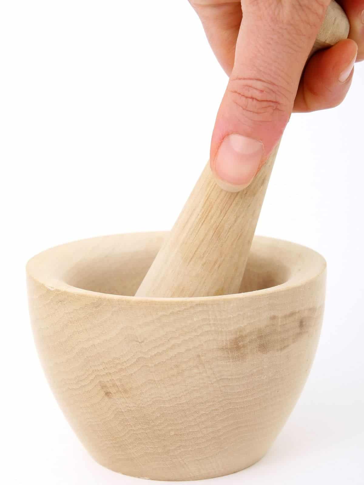 pestle being held in a mortar bowl.