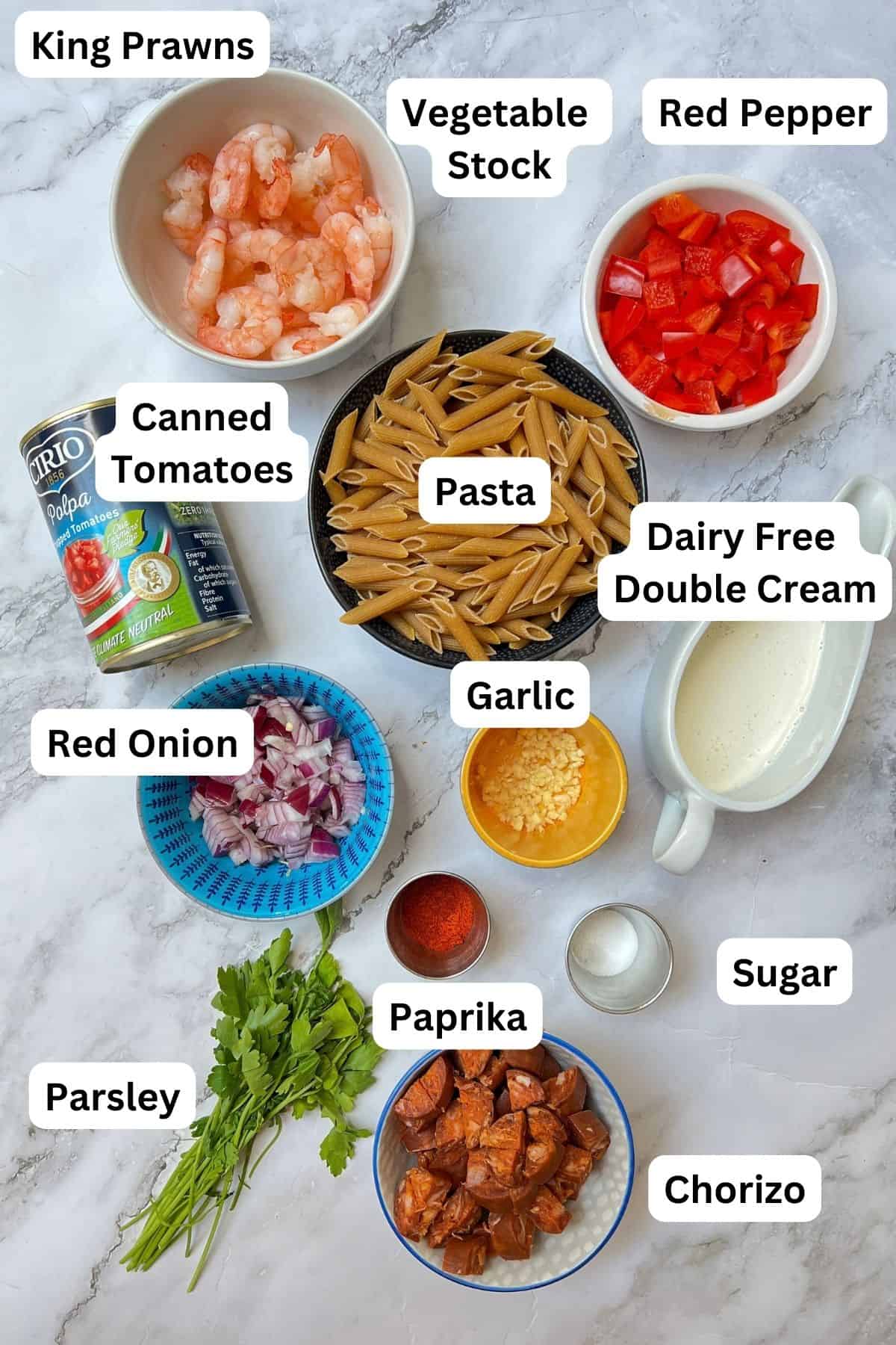 Ingredients laid out for chorizo and prawn pasta.