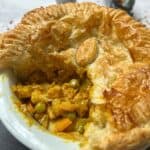 Curry pie with a slice cut out of it.