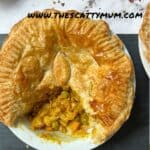 A vegetable curry pie with a slice cut out of it so you can see the filling.