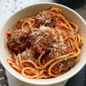 A bowl of spaghetti and meatballs.