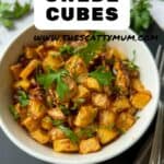 A bowl of roasted swede cubes garnished with fresh parsley.