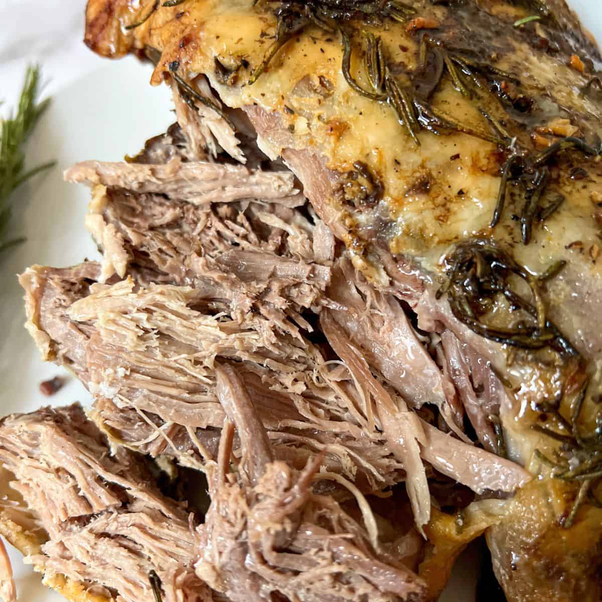 Carved leg of lamb on a plate.