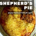 Shepherds pie in a casserole dish with a spoonful taken out of it.