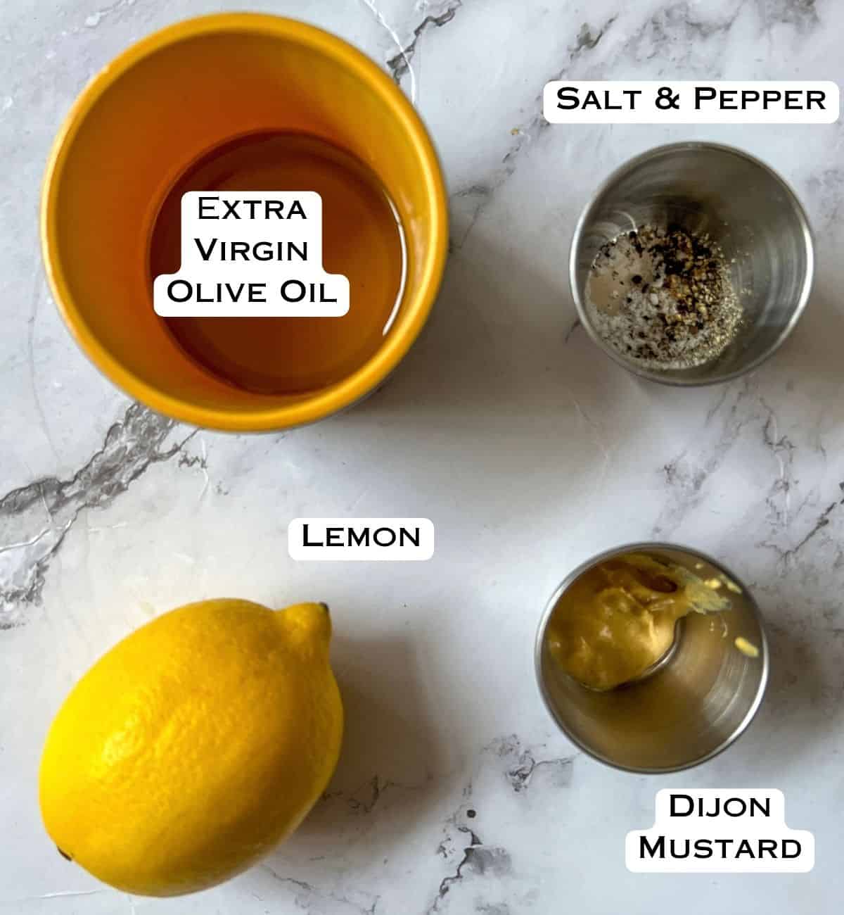 Ingredients laid out for a lemon salad dressing.