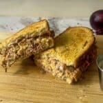 Toasted tuns sandwich on a chopping board.