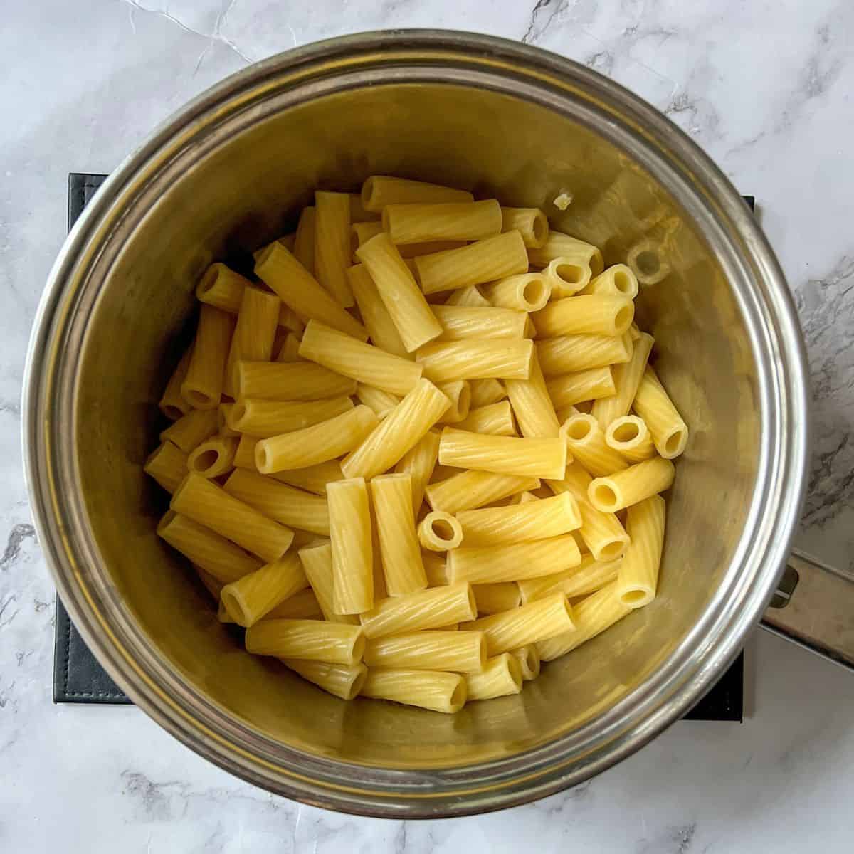 Rigatoni pasta in a saucepan.