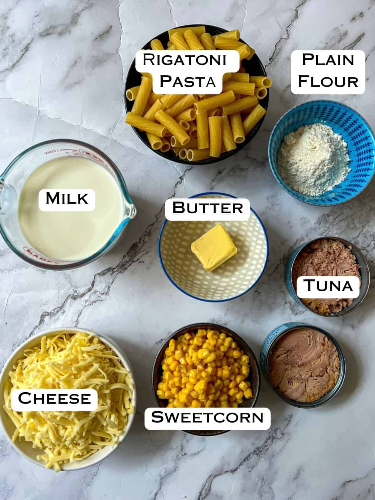 Ingredients laid out for tuna and sweetcorn pasta bake.