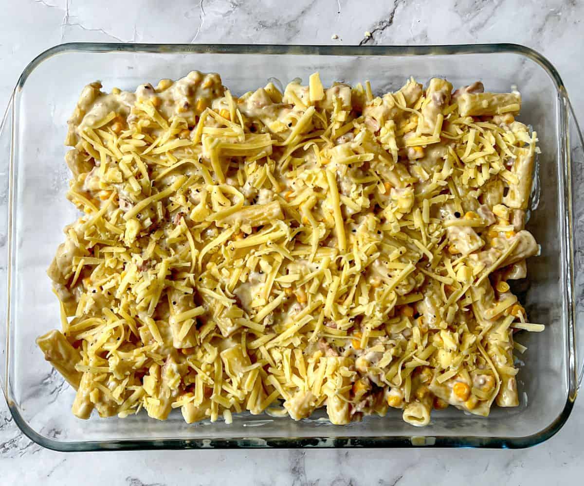 Tuna pasta topped with grated cheese in a rectangular dish.