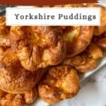 A plate piled high with Yorkshire puddings.