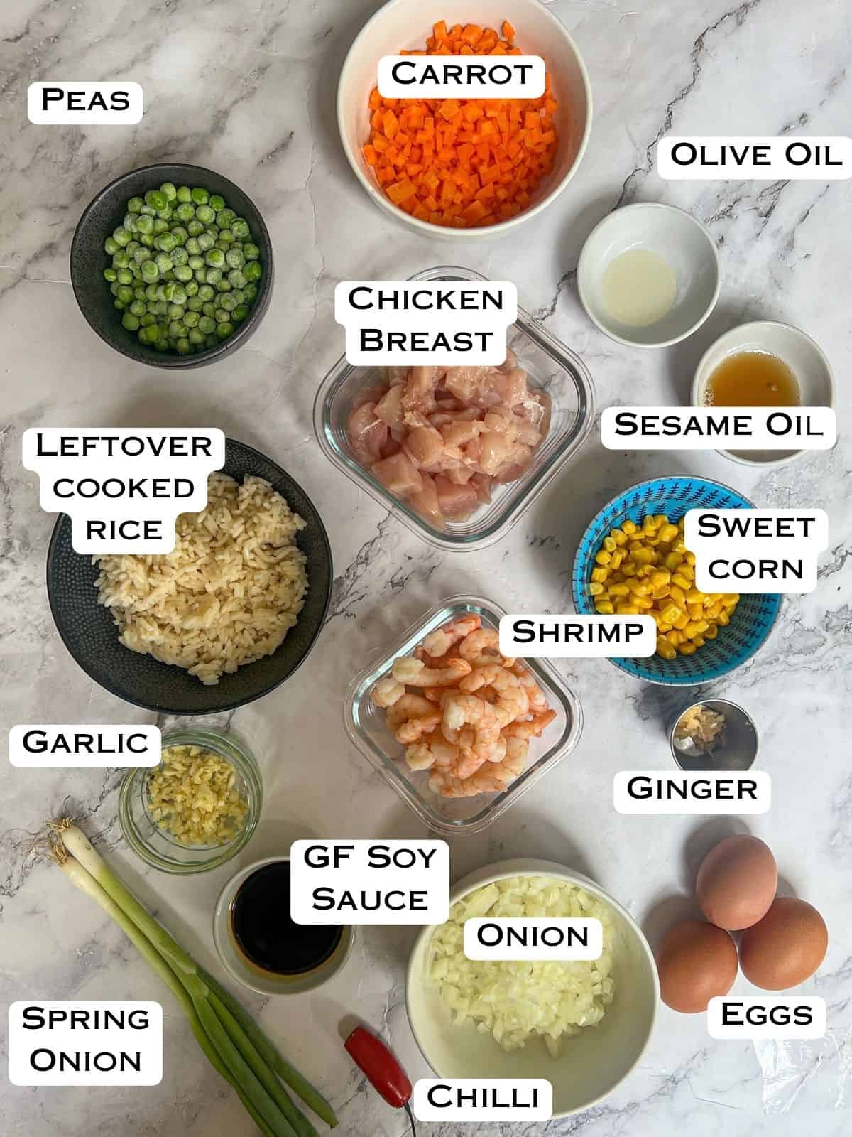 Ingredients laid out for chicken and shrimp fried rice.