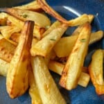 Roasted parsnips in a blue bowl.