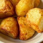 Roast potatoes in a white bowl.