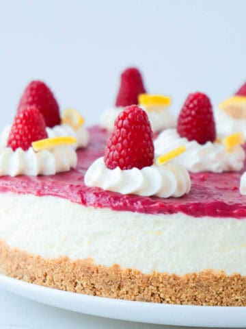 Raspberry cheesecake topped with fresh raspberries.