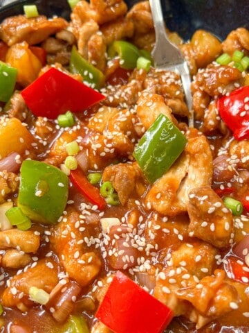 Swwet and sour chicken garnished with sesame seeds.